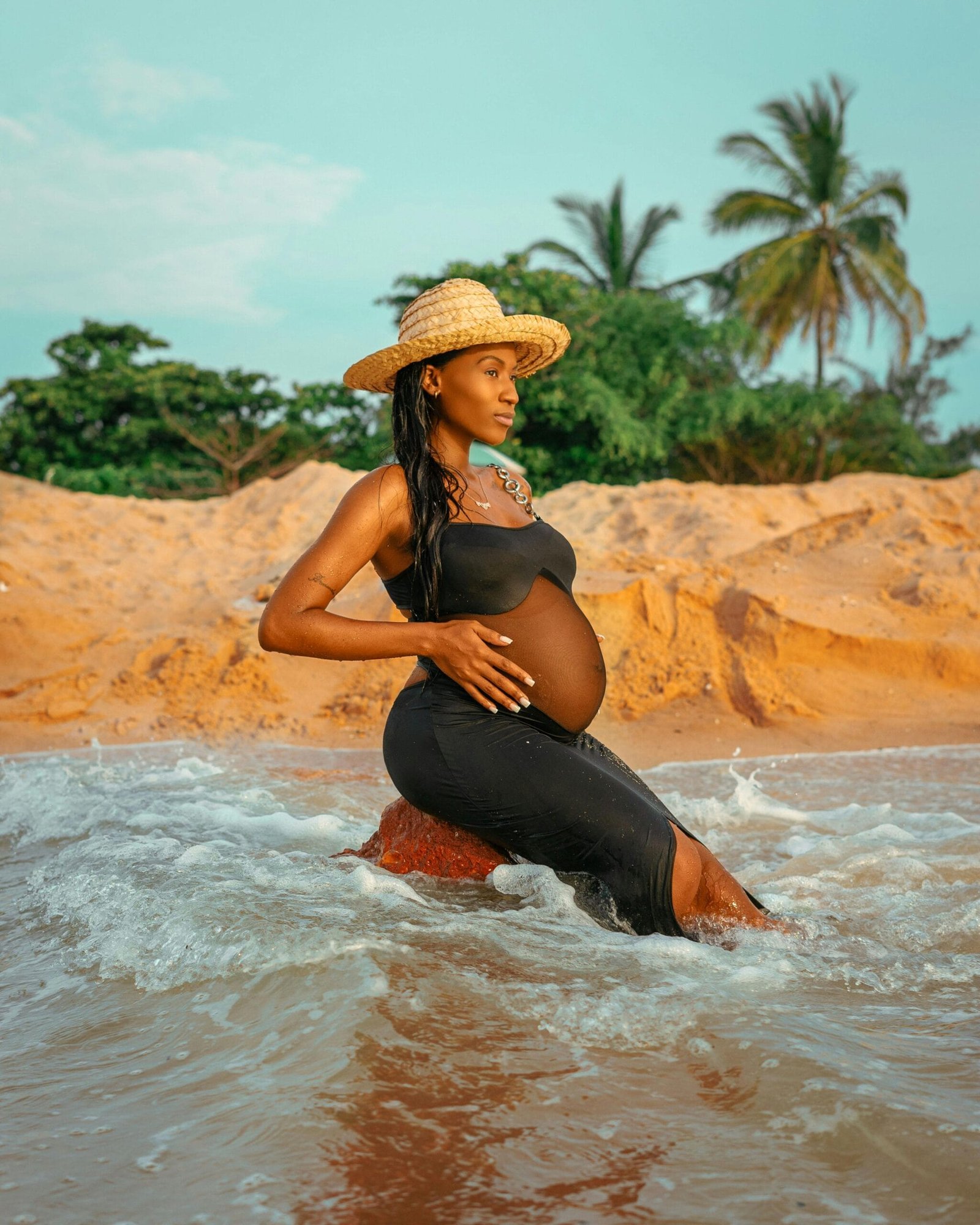 Black woman in the sea water go to have a prenatal massage